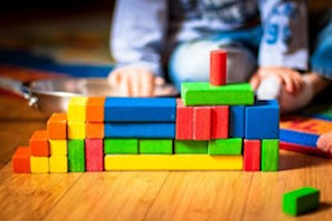 Young child playing with multi-coloured wooden blocks Young child playing with multi-coloured wooden blocks