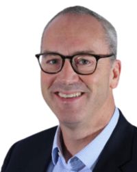 photo of ellis in a black suit jacket and blue shirt