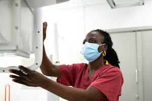A female member of staff sets up an xray machine A female member of staff sets up an xray machine