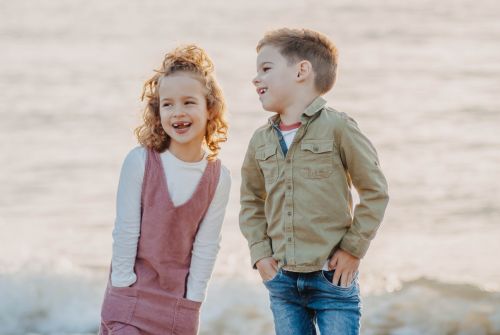 Small boy and small girl laughing