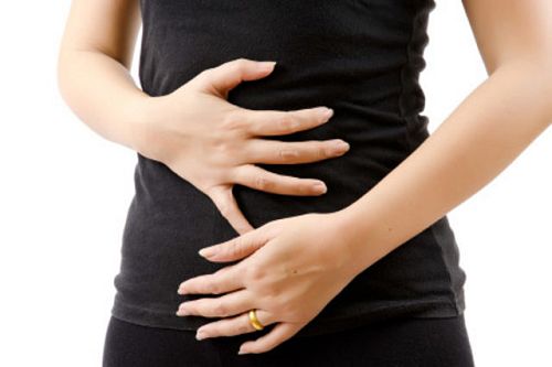 Woman clutching both hands over stomach