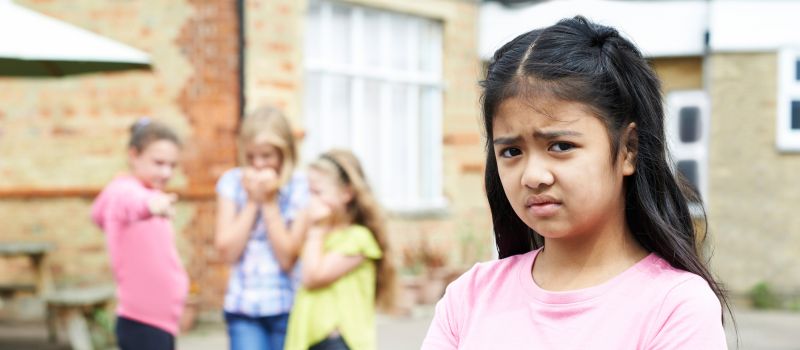 Sad child in pink t-shirt with arms crossed Sad child in pink t-shirt with arms crossed