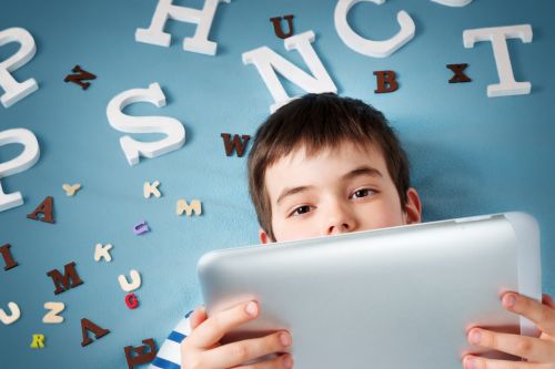 Boy holding an iPad device