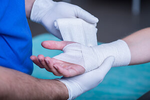 Wrapping bandage around a hand Wrapping bandage around a hand