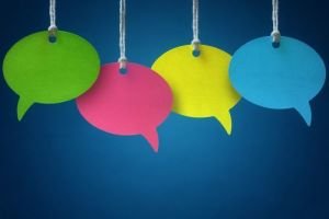 4 multi-coloured speech bubbles hanging on threads