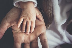 Young child hand in adult hand Young child hand in adult hand