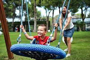 Young boy on blue donut swing