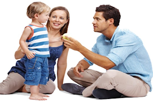 Man and woman with a young child in a stipy vest top