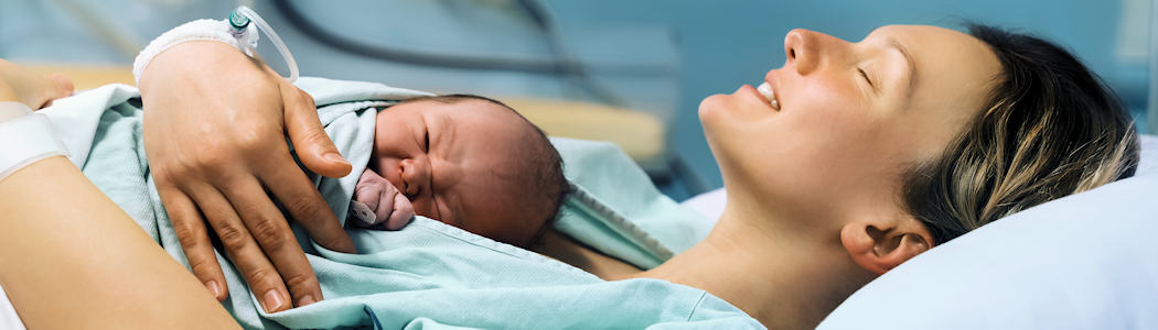 Woman holding baby after birth