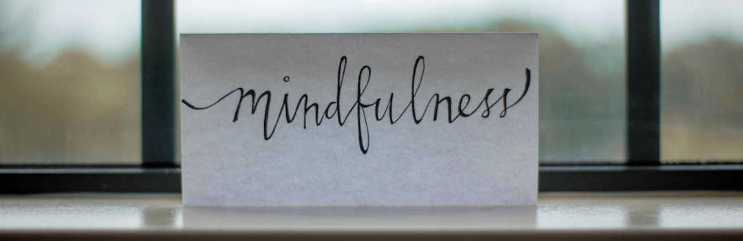The word Mindfullness on a piece of paper on a window ledge