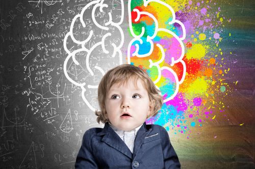 Young child with multi-coloured symbols and shapes behind