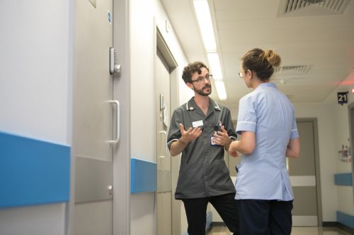 Two nurses talking in a corridor