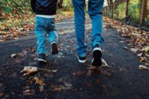 Children walking down a path covered in leaves