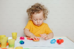 Young child playing with Playdoh