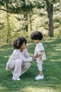 Mother and young child standing in a wood