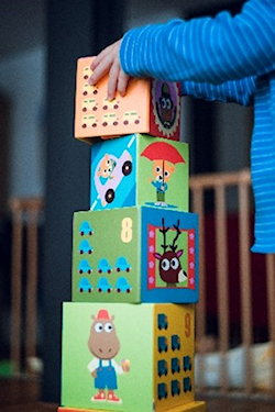 Young child building a tower out of boxes