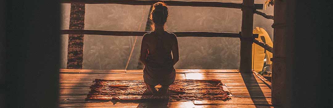 Woman kneeling in yoga position