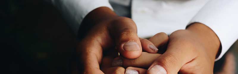 Person holding one hand in the other Person holding one hand in the other