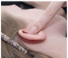 Press the skin over ear canal