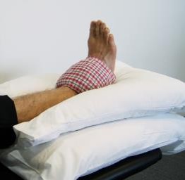 Image of person's foot raised on pillow