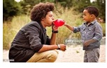 Baby and man blowing a balloon