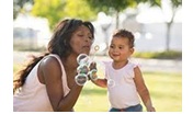 Baby and woman blowing bubbles