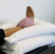 Image of person's foot raise on cushions