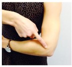 Image of person pointing at their elbow