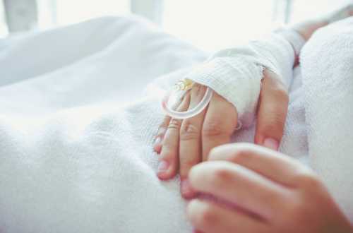 Cannula in bandaged hand Cannula in bandaged hand