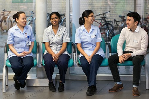 Four International Nurses sitting down Four International Nurses sitting down