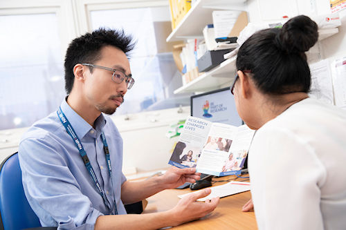 Doctor discussing research with a colleague Doctor discussing research with a colleague